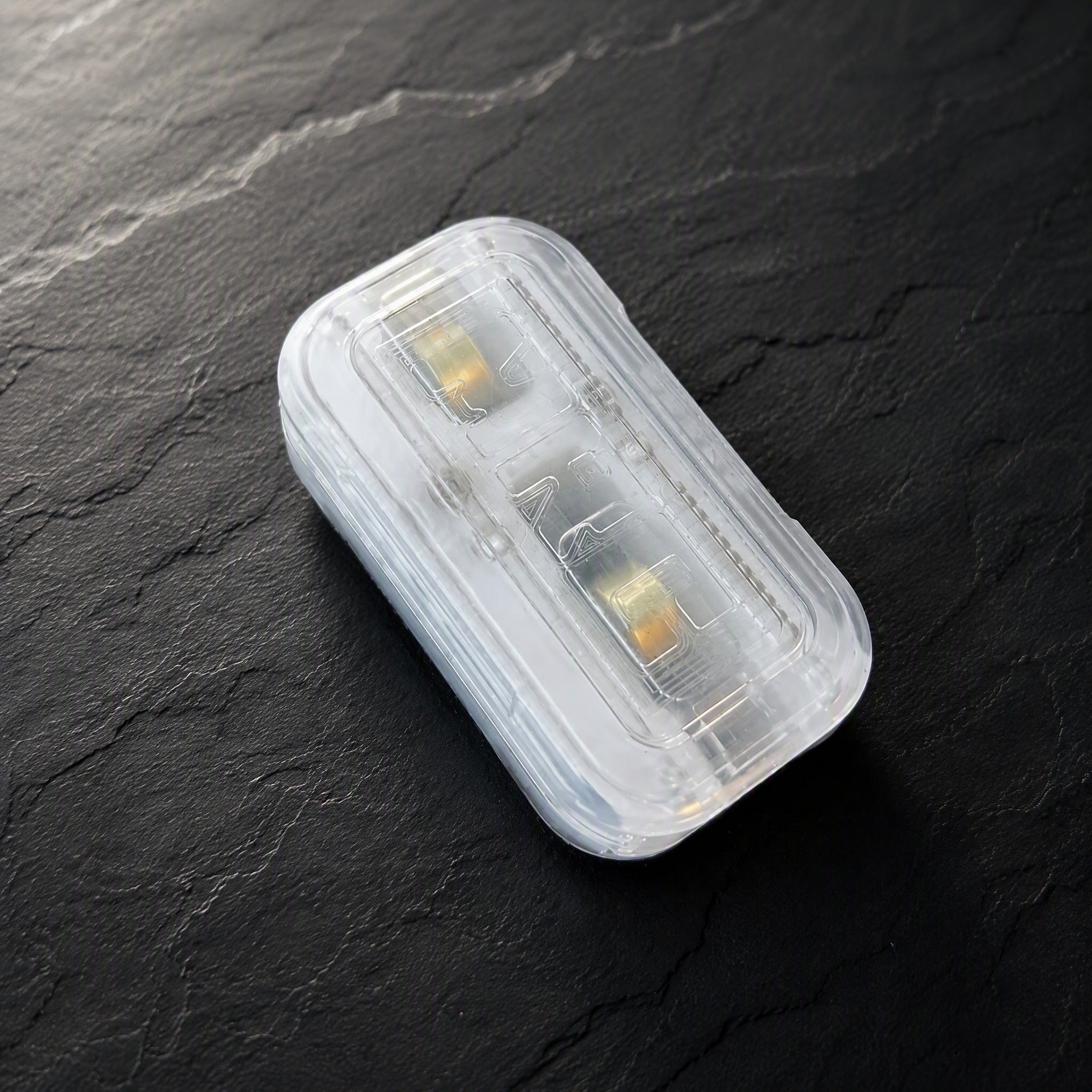 Transparent fidget slider scene on dark stone