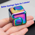 MataFlick Metal Fidget Cube in hand — iridescent multicolor finish