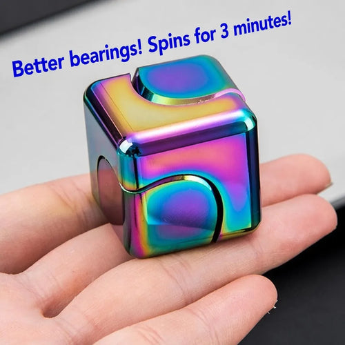 MataFlick Metal Fidget Cube in hand — iridescent multicolor finish