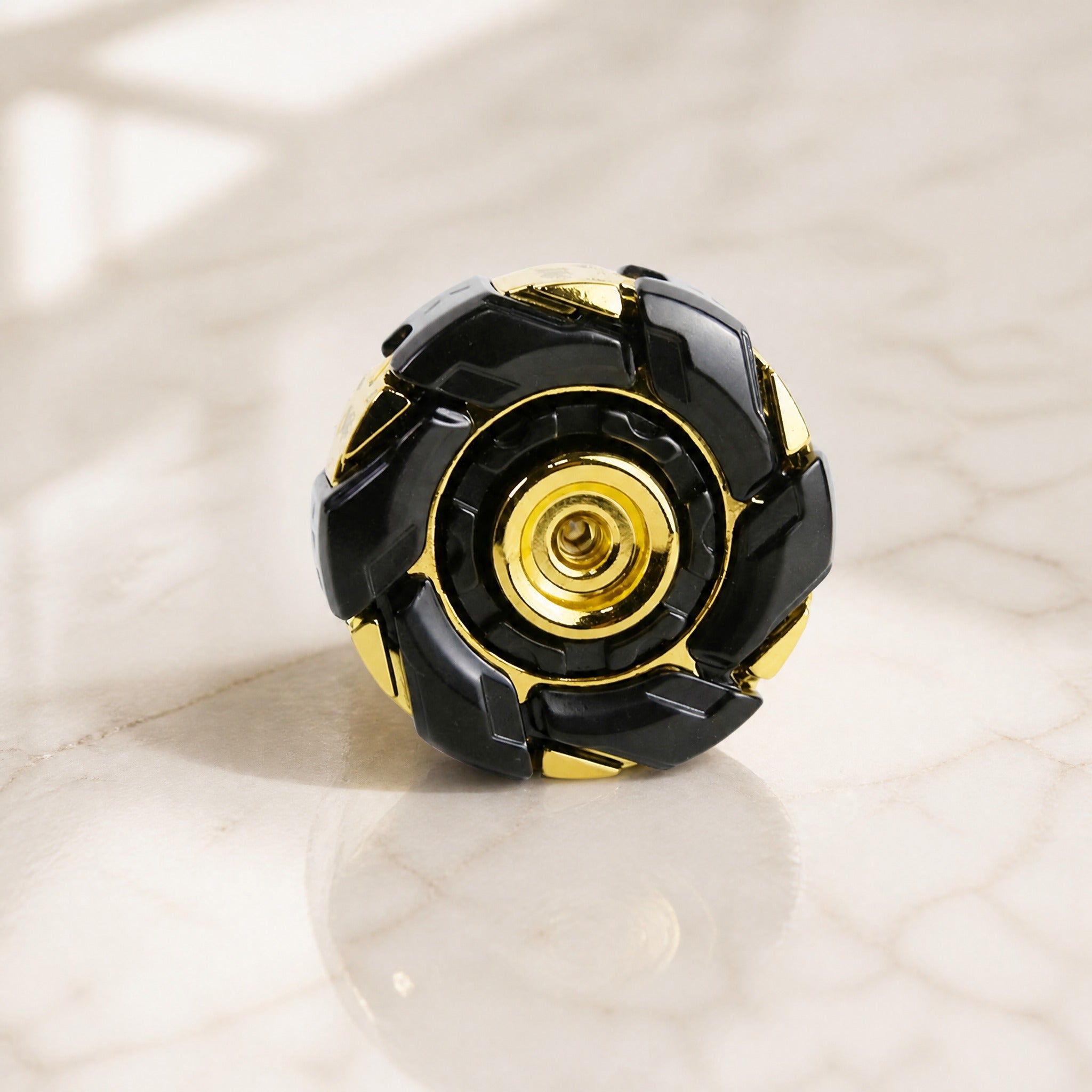 Spinning battle top on marble surface