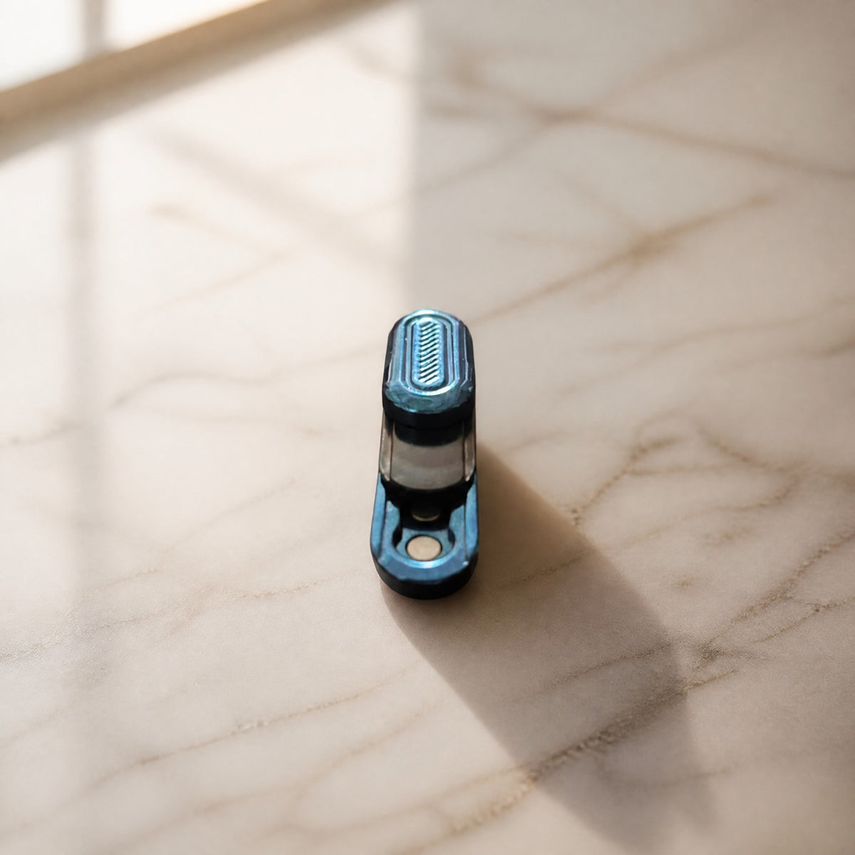 Capsule fidget slider on marble surface
