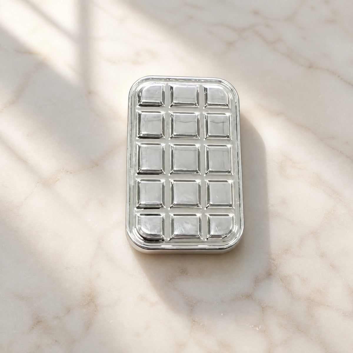 Metal fidget slider grid bar on marble surface